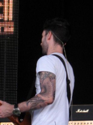 Adam Levine With Guitar And Guitar Tattoo On Hand